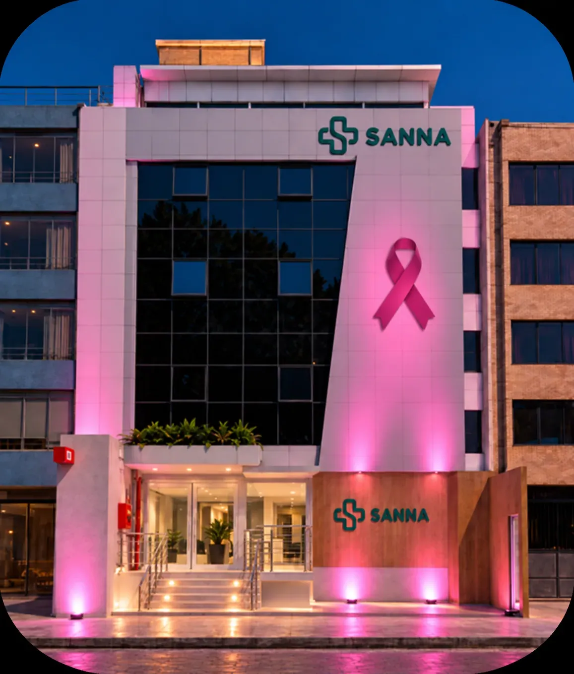 Clínica Sanna iluminada de rosa al anochecer